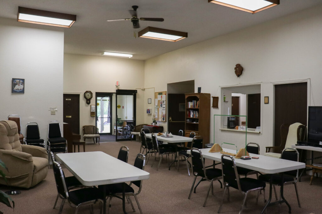 View of tenant lounge  area tables and tenant kitchen 