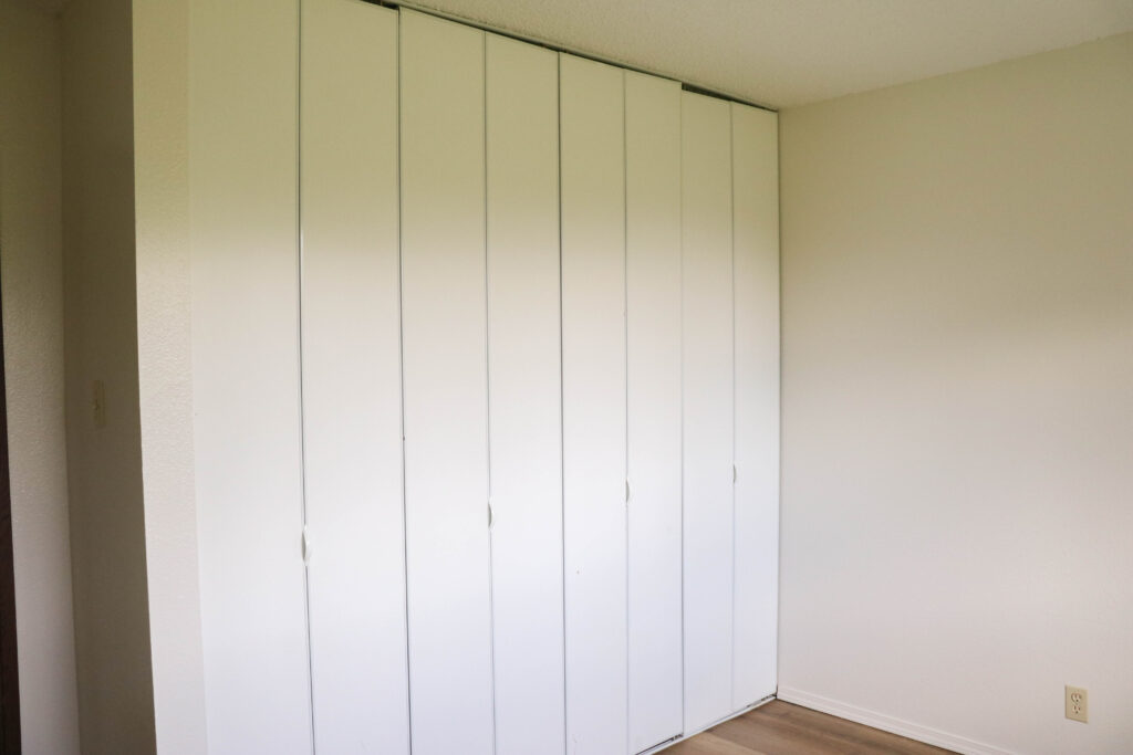 Large closet spanning one wall. eight closed doors.